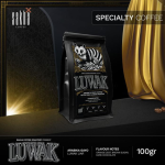 Wild Gayo Luwak specialty coffee 100g bag displayed with gold drapery backdrop
