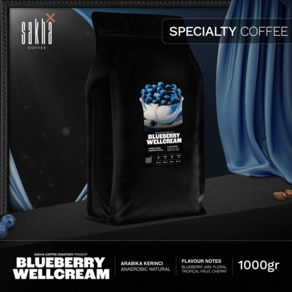 Blueberry Wellcream specialty coffee 1kg bag packaging displayed on dark set with curtain backdrop