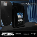 Blueberry Wellcream specialty coffee 500gr bag packaging displayed on dark set with curtain backdrop
